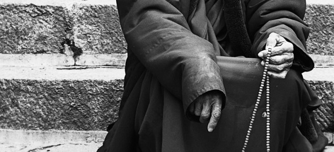 monk holding prayer beads